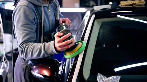 the Car Mechanic at a Service Station Doing the Final Polishing to Shine