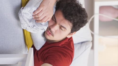Young Adult Sleeping Peacefully on Sofa Indoors