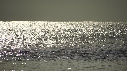 Abstract Shining Sun Reflections on Blue Surface of Sea Waves Bokeh Sun Glare Reflected in Water