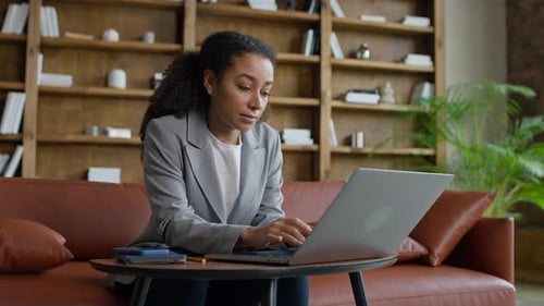 Businesswoman Working on Laptop in Modern Office