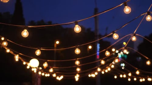 A View From Below of a Lot of Small Light Bulbs a Festive Garland Illuminating the Night Sky
