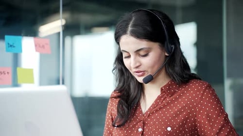 Friendly Woman with Headset Engaged in Video Conference