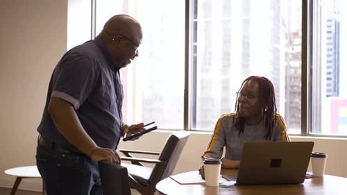 Business People with Digital Tablet and Laptop Talking in Office 2529 Years