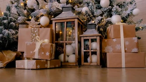 Presents Stacked Near Christmas Tree and Lanterns