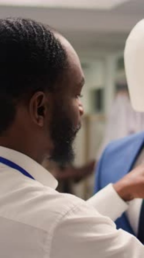 Vertical Video Man Arranges Mannequin in Fashion Shop