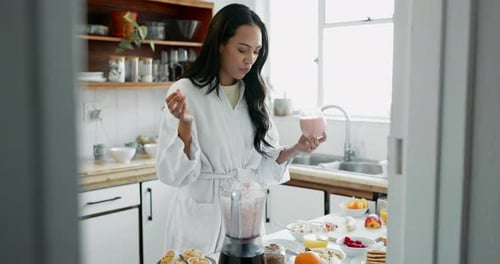 Woman in Robe Makes a Morning Smoothie