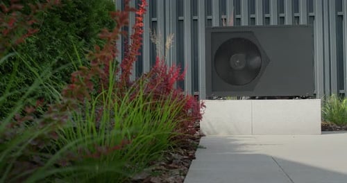 The Heat Pump for Heating the Pool is Mounted on Site Ornamental Plants Nearby Energy Saving