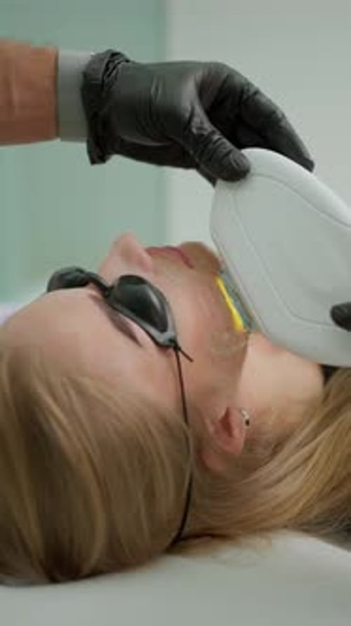 Woman Receives Facial Laser Treatment in Clinic