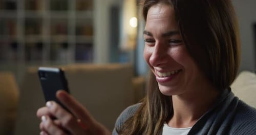 Smiling Woman Using Mobile Phone Indoors