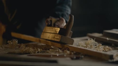 Hands Smoothing Plank with Wood Plane