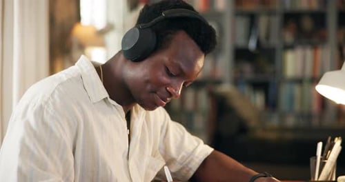 Student, library and man with headphones on laptop for online learning, studying and education