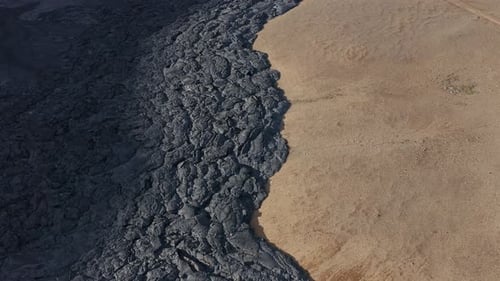 Edge of black basalt field solidified lava dark rock, aa flow, Iceland