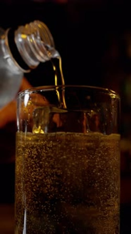 Pouring Fizzy Soda Into Glass with Bubbles