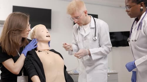 Medical Staff Performing Medical Procedure on Medical Training Doll