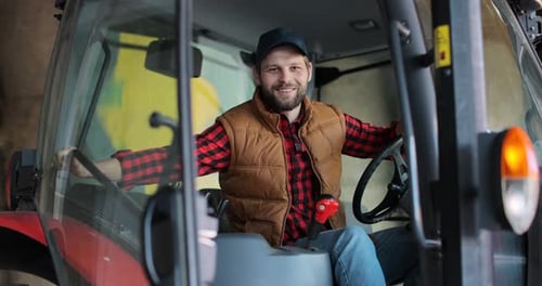 Farmer Smiling in Tractor on the Farm