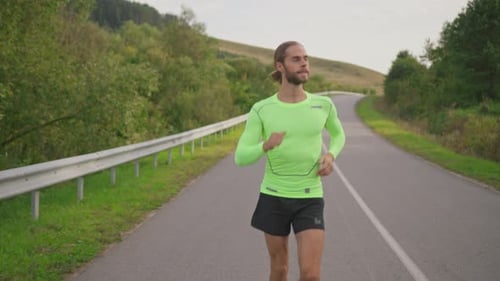 Bearded Active Male Runner Smiling Confident Jogging on Empty Country Road Highway Outdoors