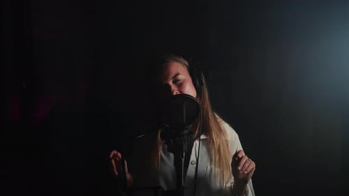 Female Podcaster Recording Audio in the Studio