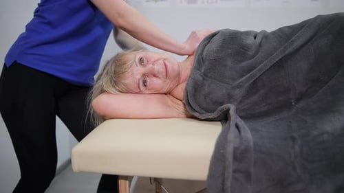 Senior Woman Relaxing During a Shoulder Massage