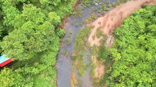 drone following canal in greenery forest in konkan