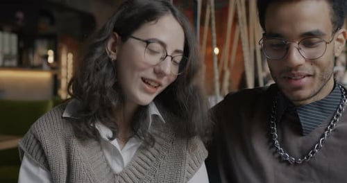 Beautiful Biracial Couple Talking Smiling and Drinking Coffee From Cups in Cafe