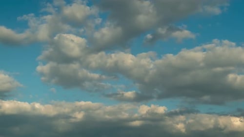 Time lapse against the blue sky white clouds. Smooth puffy clouds in the air.