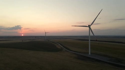 Windmills Harnessing Electric Power at Sunset in a Serene Windmill Park Promoting Green Energy and