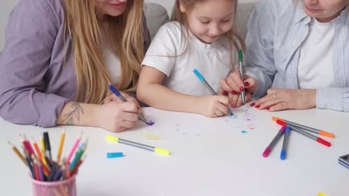 Three Generations Drawing Together at White Table