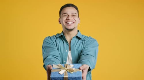 Man Smiles and Offers a Birthday Gift