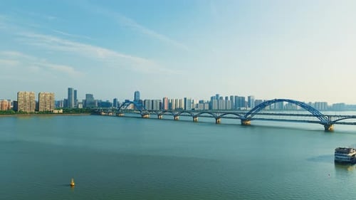 Aerial View of a Busy Bridge with Cars Crossing Over Tranquil Waters in a Vibrant City