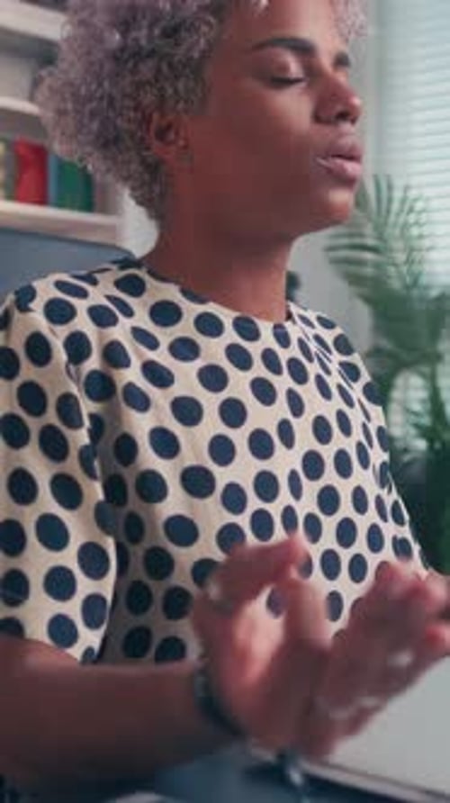 Woman Meditating at Desk in Office Setting