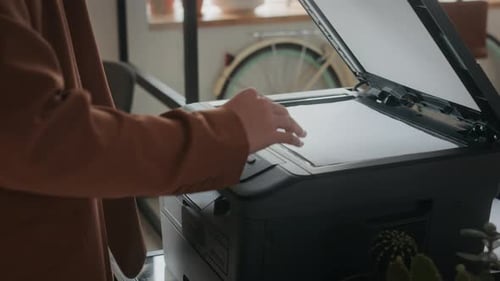 Close Up of Female Office Worker Scanning Document on Printer