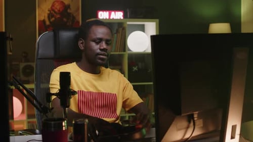 Young Adult Using Computer Equipment for Streaming