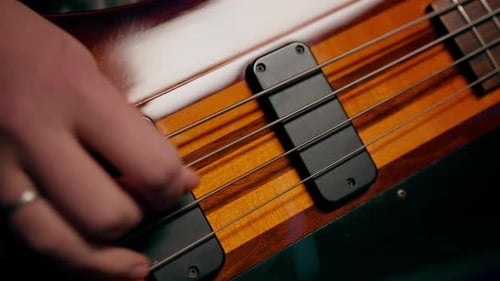 rock performer with electric guitar in recording studio recording playing own track creating song