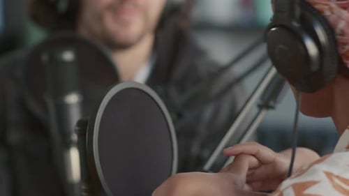 Female Host Speaking with Guest While Recording Podcast