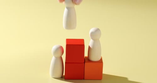 Wooden Figures on Blocks Depicting Success and Achievement