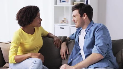 Man and Woman Chatting on Sofa at Home