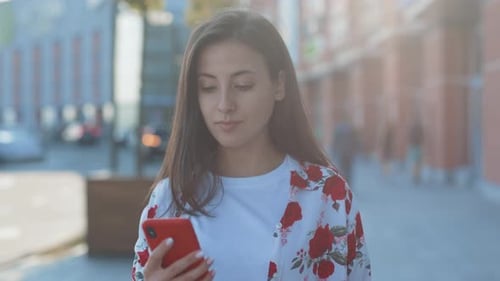Outdoor Portrait of Beautiful Caucasian Young Woman with Mobile Phone in the Street Closeup Smart