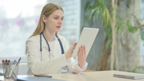 Doctor Browsing Tablet in Clinic