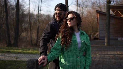 Loving Couple Embracing Outdoors in a Sunny Park