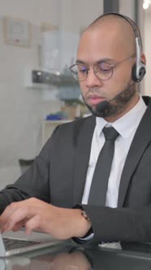 Call Center Employee with Headset Working in Office, vertical video