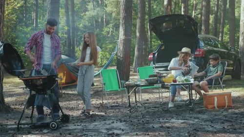 Family Picnic in Forest with Dad Cooking Barbeque