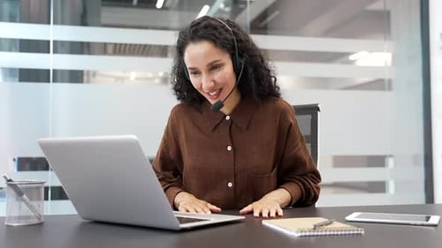 Woman Video Conferencing with Laptop in Modern Office