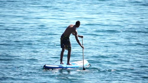 Man Sup Sea Strong Athletic Man Learns to Paddle Sup Standing on Board in Open Sea Ocean on Sunny