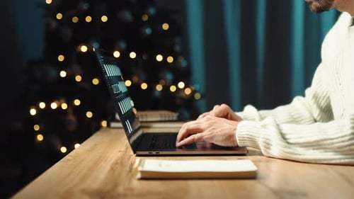 Working on Laptop While Sitting at Home with Christmas Decorations