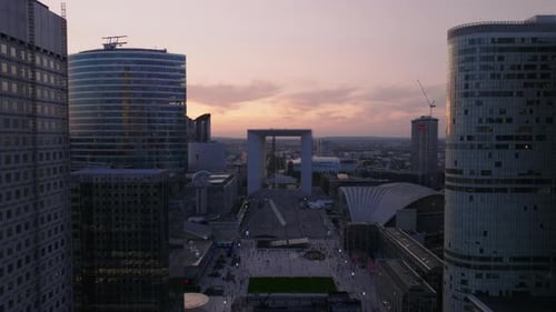Forwards Fly Above Modern Urban Borough Skyscrapers in La Defense Business and Financial Hub at Dusk