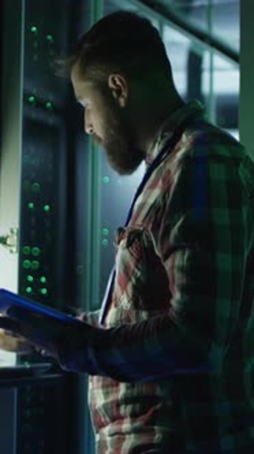 Man Using Laptop Digital Tablet in Data Center