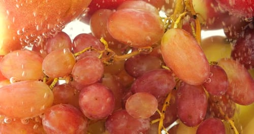 Background with fruits and berries in water with air bubbles.