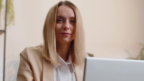 Business Woman Freelancer at Office Workplace Desk Working on Laptop Computer Sends Online Messages