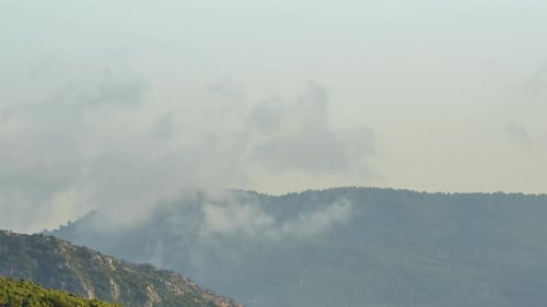 Clouds and Mist Over Mountainous Landscape