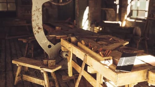 Workshop with Tools and Machinery in a Rustic Setting During Daylight Hours
